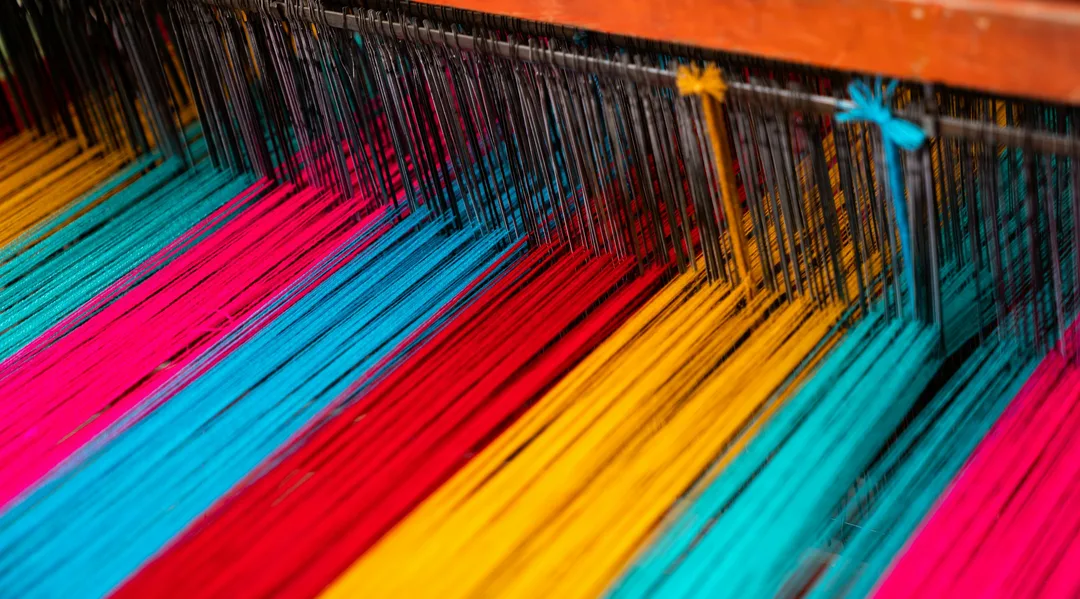 Bright warp threads strung on a loom