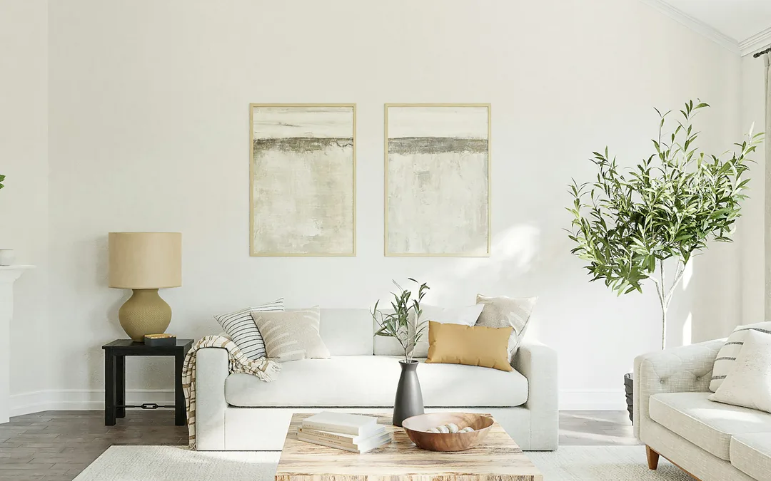 A calm living room with a neutral sofa and a fireplace