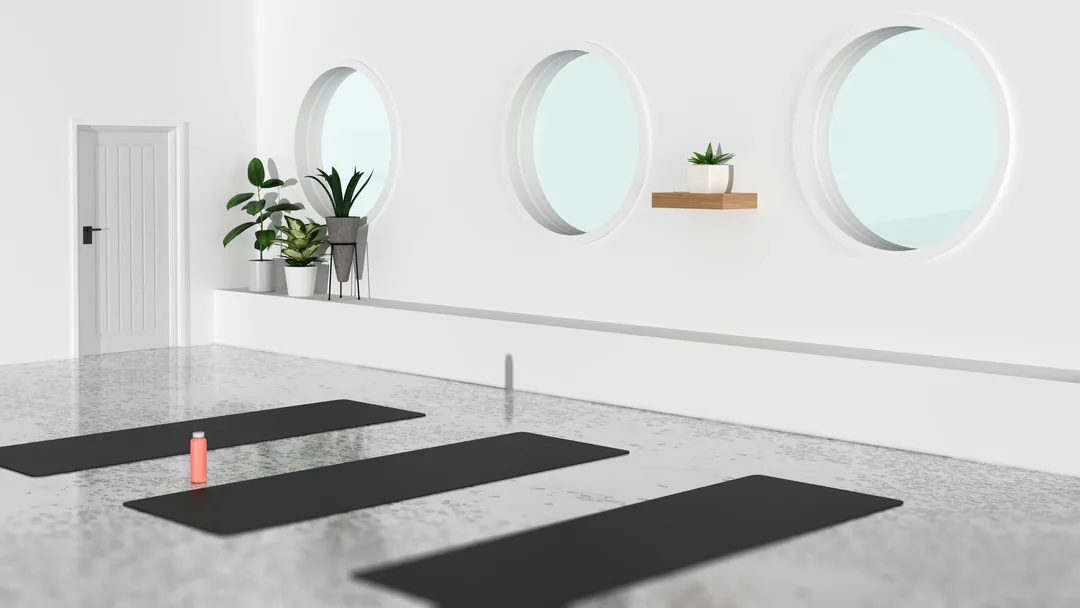 A light, empty studio with yoga mats on the floor